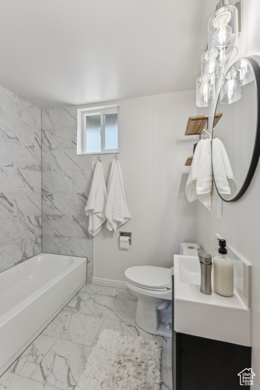 Bathroom featuring vanity, marble look tile flooring, and shower / bath combination