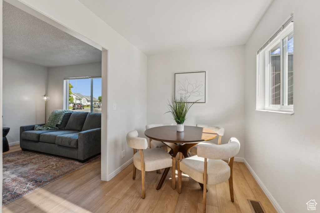 Dining room featuring light wood finished floors and baseboards