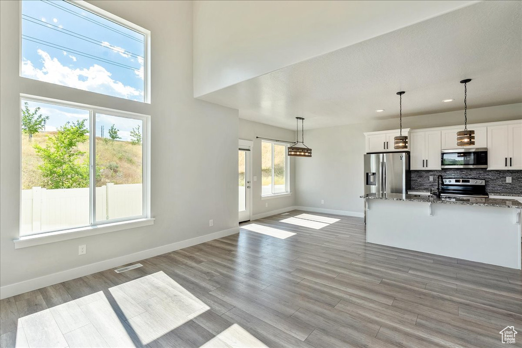 Unfurnished living room featuring recessed lighting and light wood-style floors