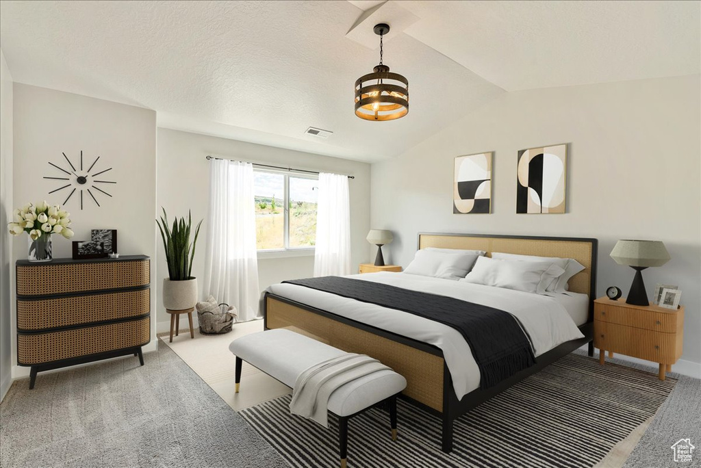 Bedroom with lofted ceiling, carpet, and a chandelier