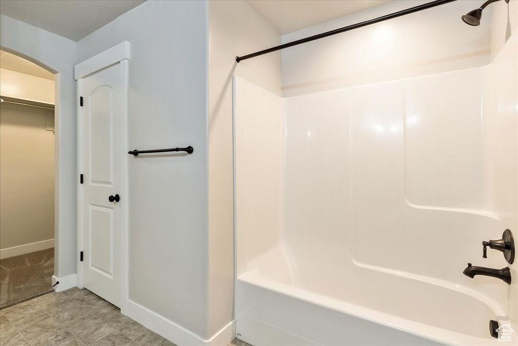 Bathroom with shower / bathtub combination and a spacious closet