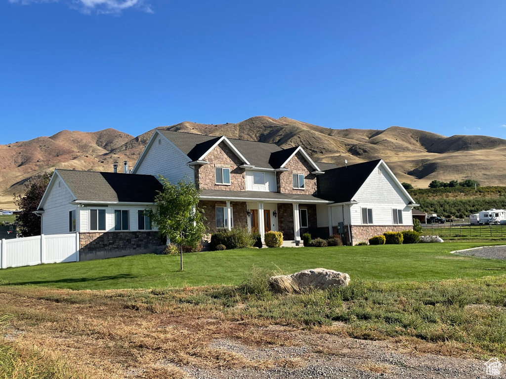 Craftsman-style home featuring stone siding and a mountain view