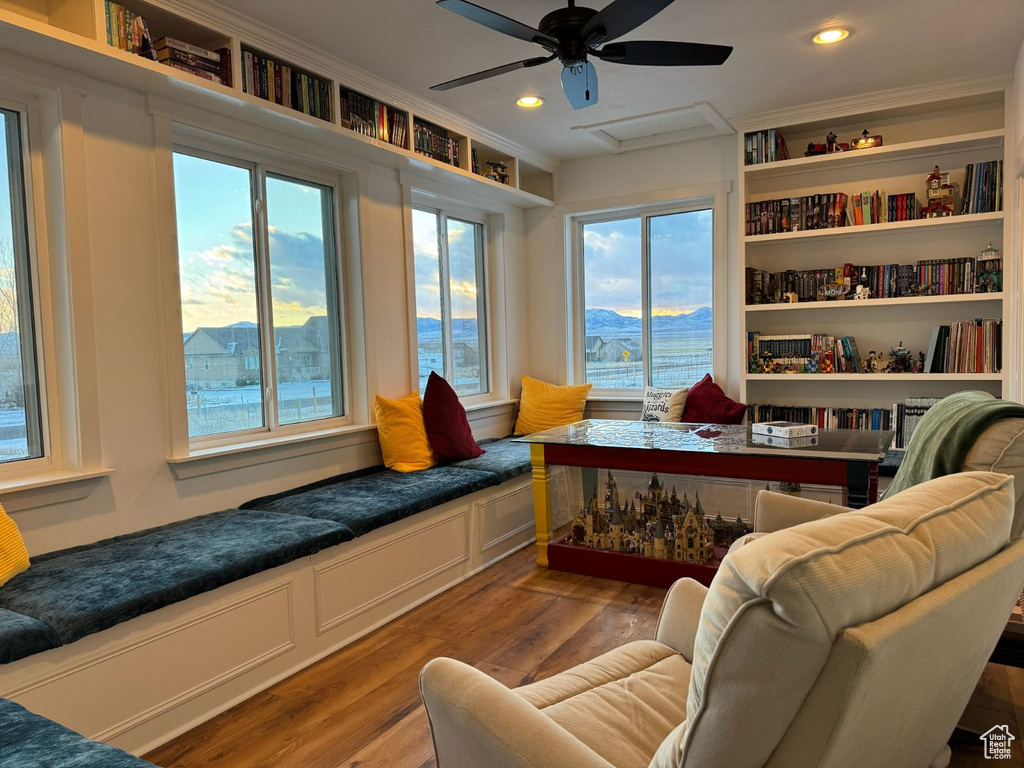 Living area featuring light wood-type flooring, plenty of natural light, ornamental molding, a ceiling fan, and recessed lighting
