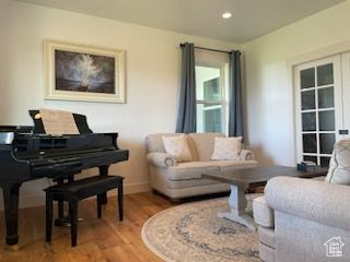 Living area featuring light wood-style floors and recessed lighting