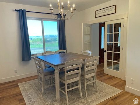 Dining area featuring a chandelier and wood finished floors