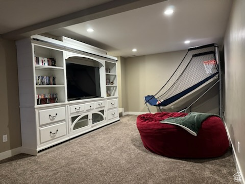 Carpeted living area featuring recessed lighting and baseboards