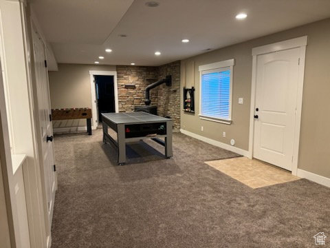 Rec room with a wood stove, carpet flooring, and recessed lighting