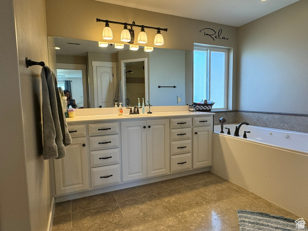 Bathroom featuring vanity and a garden tub