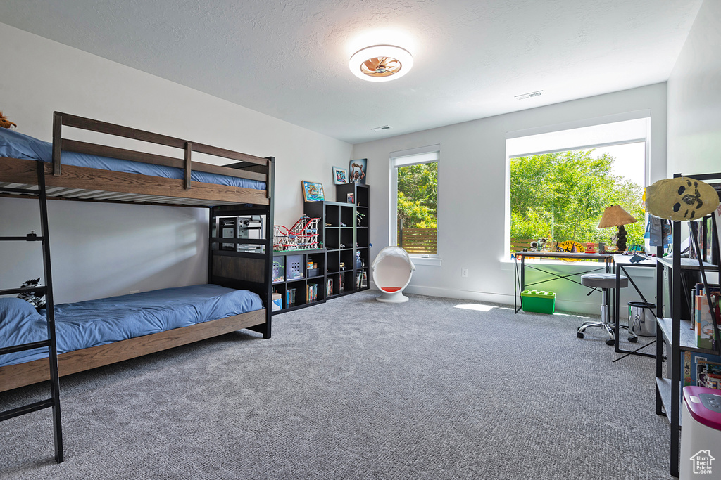 Carpeted bedroom featuring baseboards