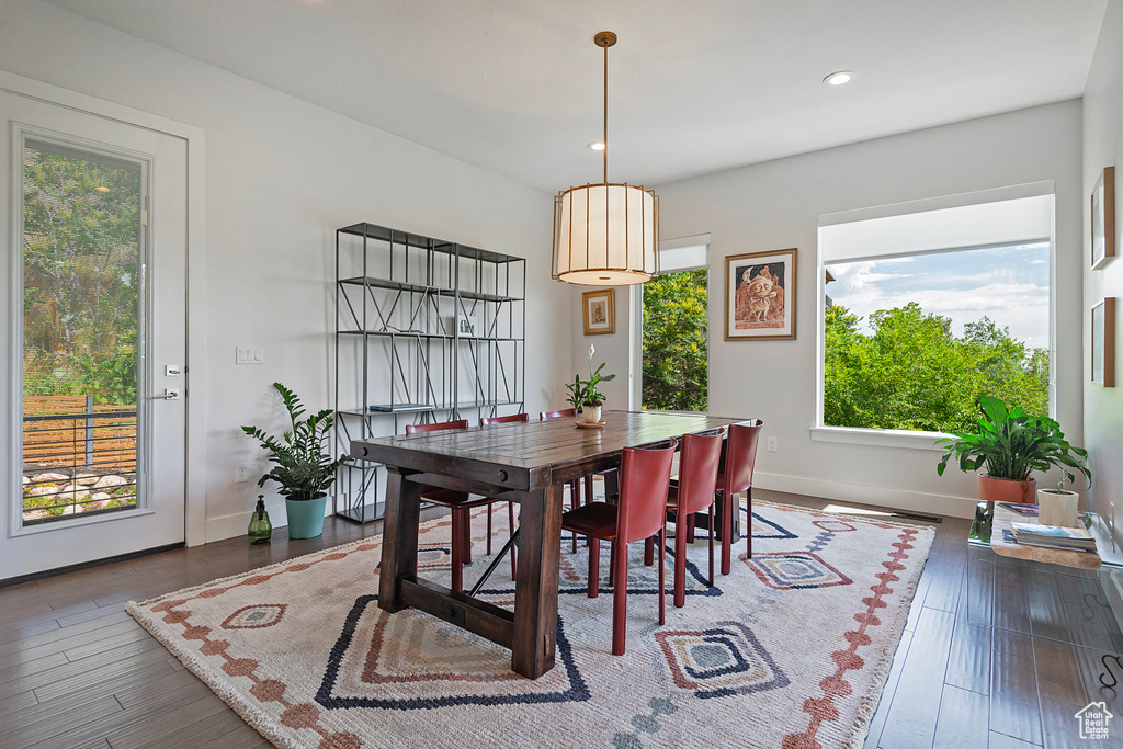 Dining room with wood finished floors and recessed lighting