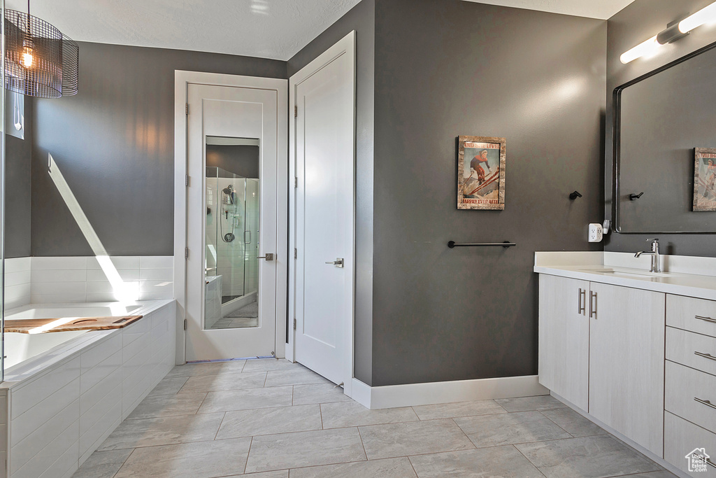 Full bathroom with vanity, a shower stall, and a bath