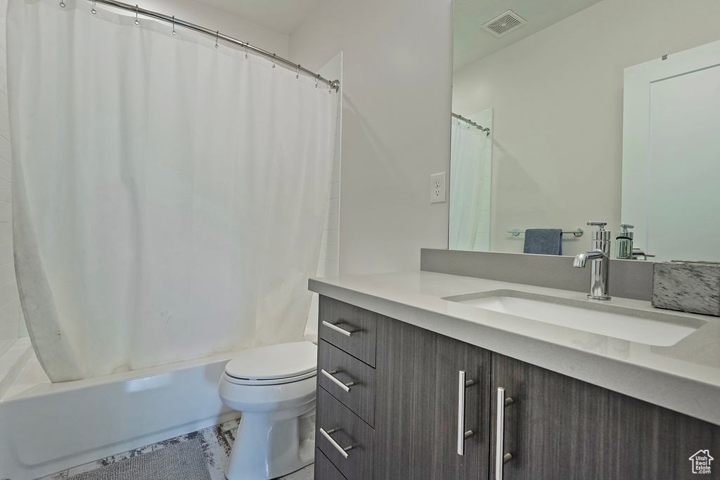 Bathroom with vanity and shower / bath combination with curtain