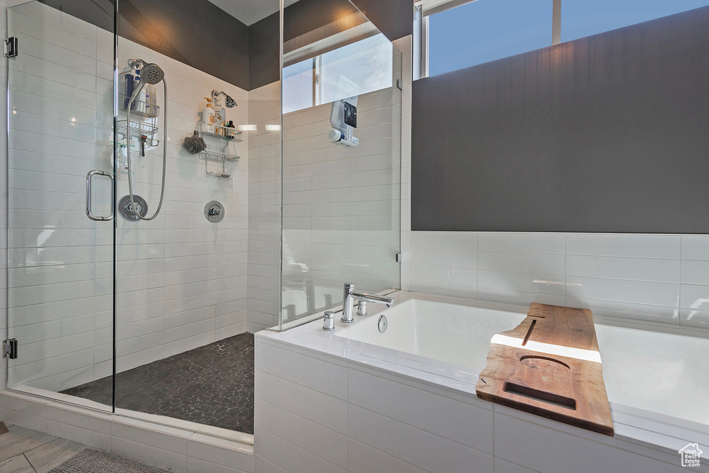 Full bath featuring a shower stall and a garden tub