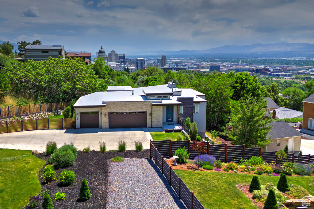 Modern home featuring driveway, a garage, and stucco siding