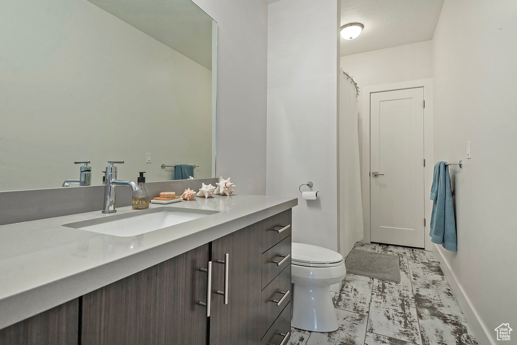 Full bathroom featuring vanity and curtained shower