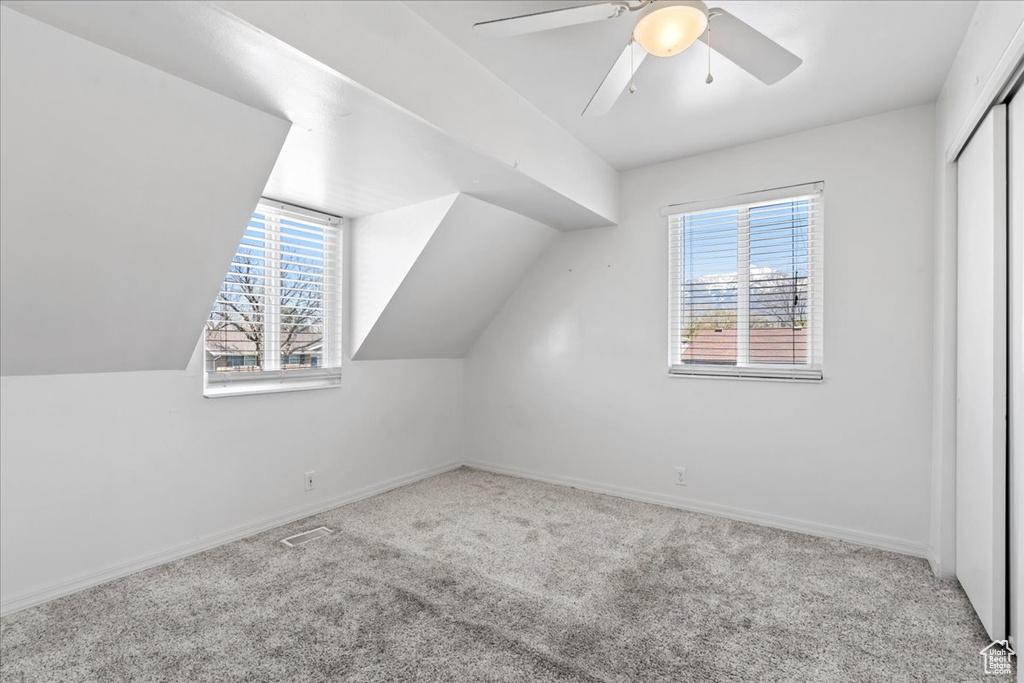 Bonus room featuring carpet flooring, a ceiling fan, and lofted ceiling