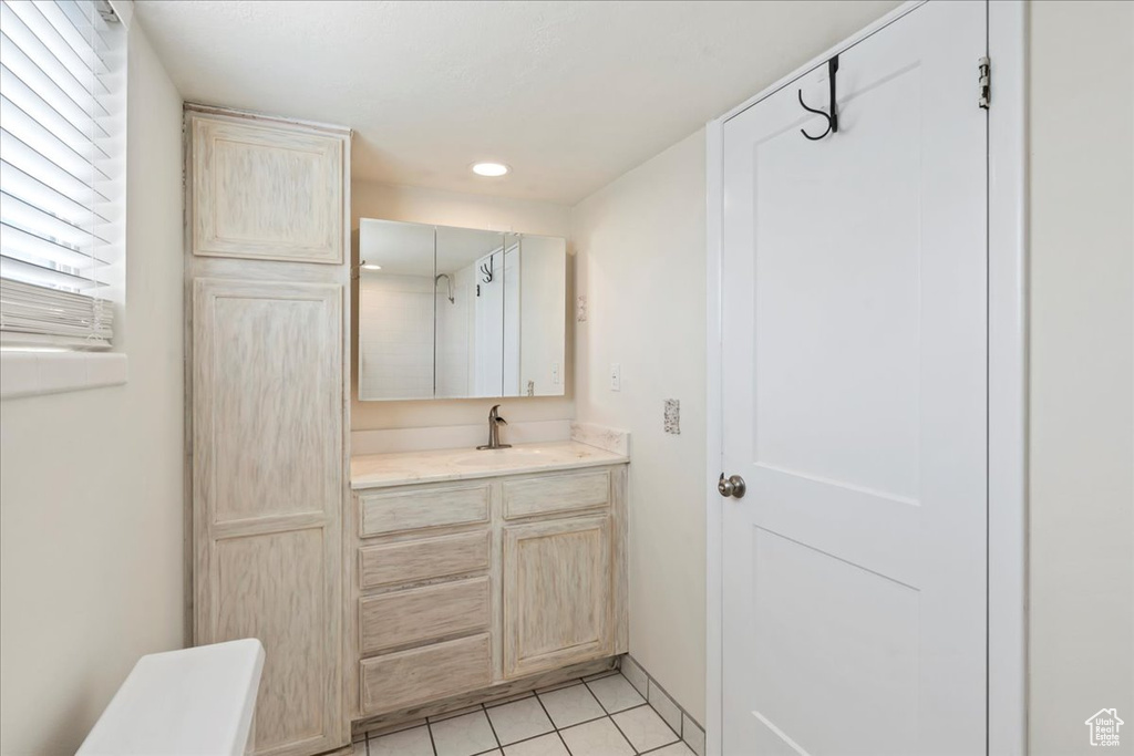 Bathroom with vanity, tile patterned flooring, and recessed lighting