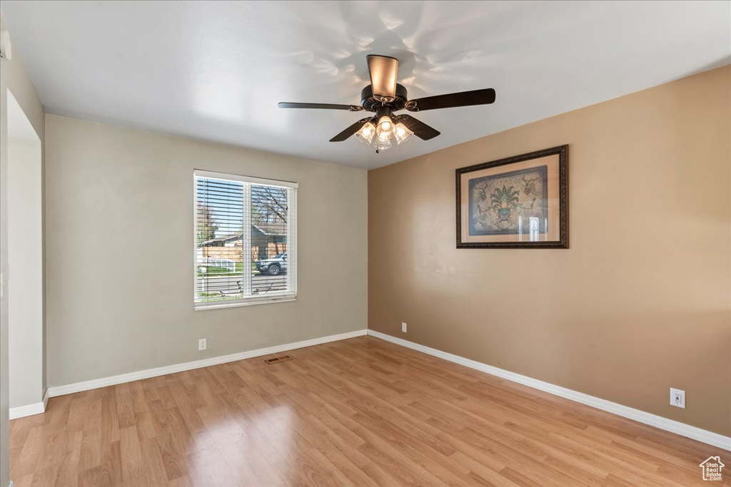Spare room with light wood-style flooring and a ceiling fan