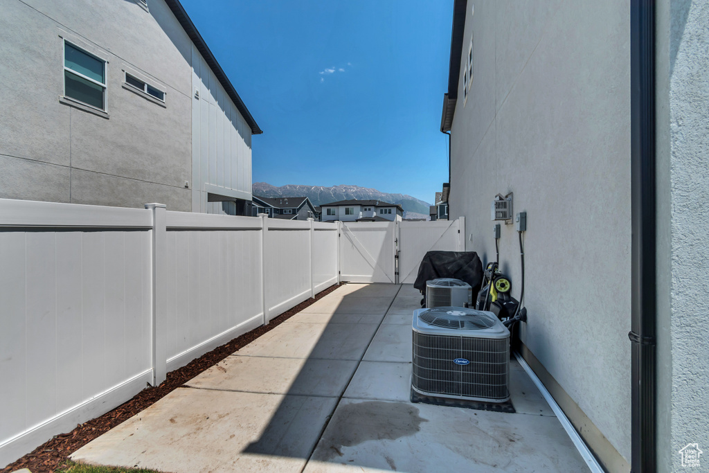 Fenced backyard featuring a gate, a patio area, and a mountain view