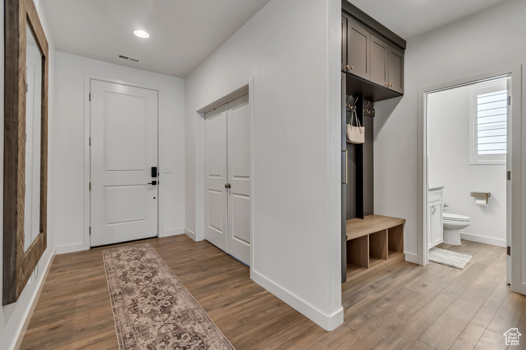 Mudroom with wood finished floors and recessed lighting