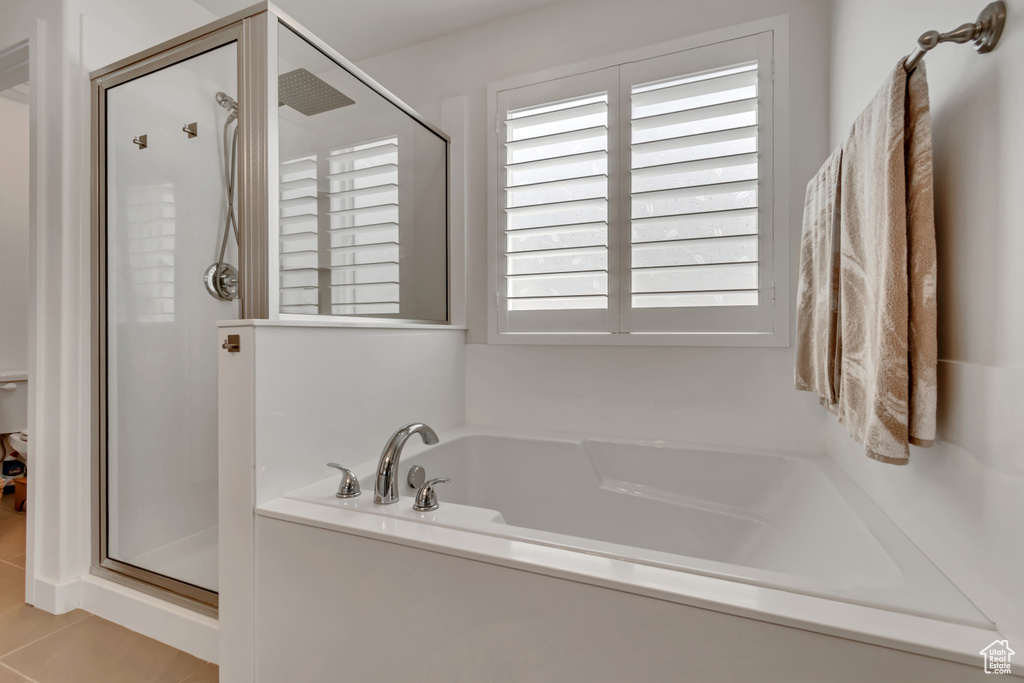 Bathroom with a shower stall, a garden tub, and tile patterned flooring