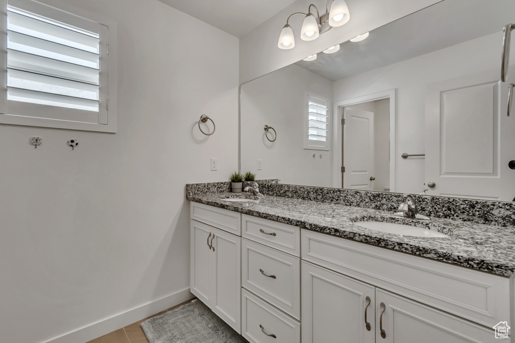 Bathroom featuring double vanity and tile patterned flooring