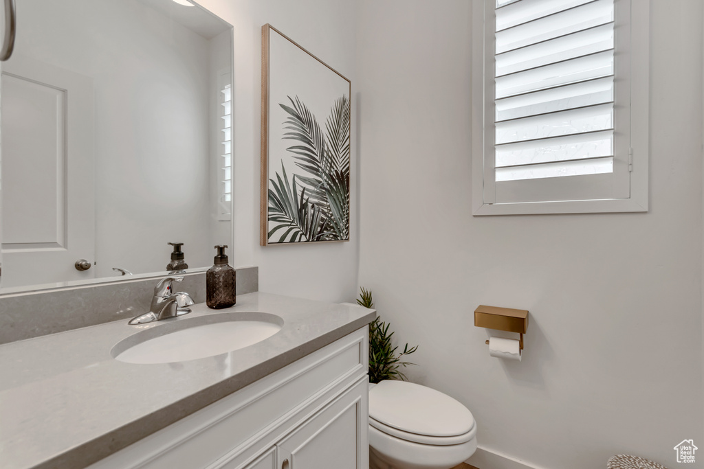 Half bathroom with vanity and healthy amount of natural light
