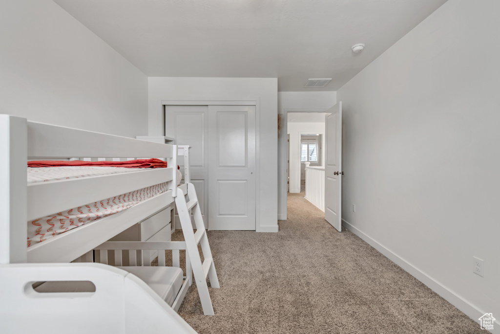 Bedroom featuring carpet floors and a closet