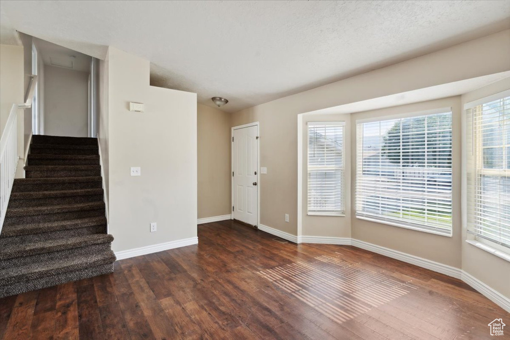 Entrance foyer with hardwood / wood-style floors and stairway
