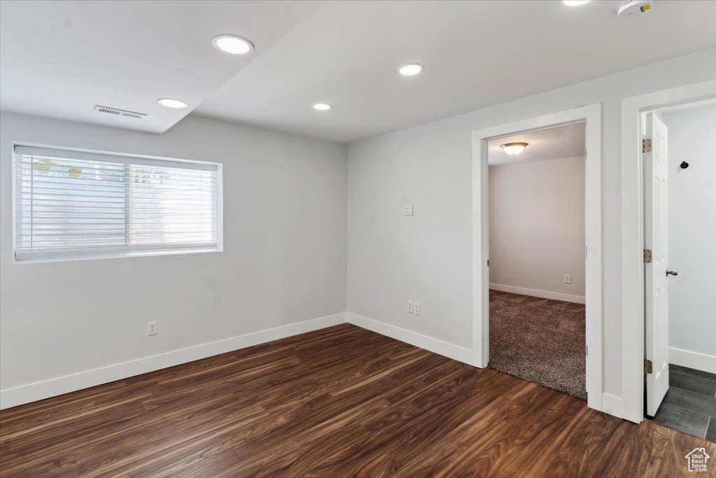 Spare room with dark wood finished floors, recessed lighting, and a smoke detector