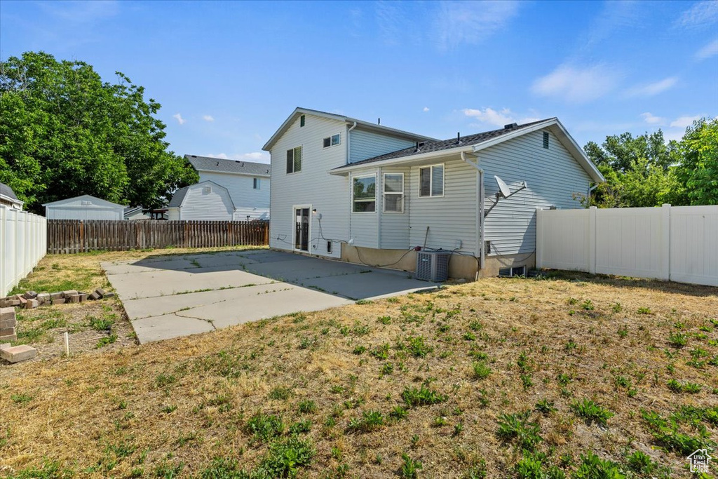 Back of property with a patio and a fenced backyard