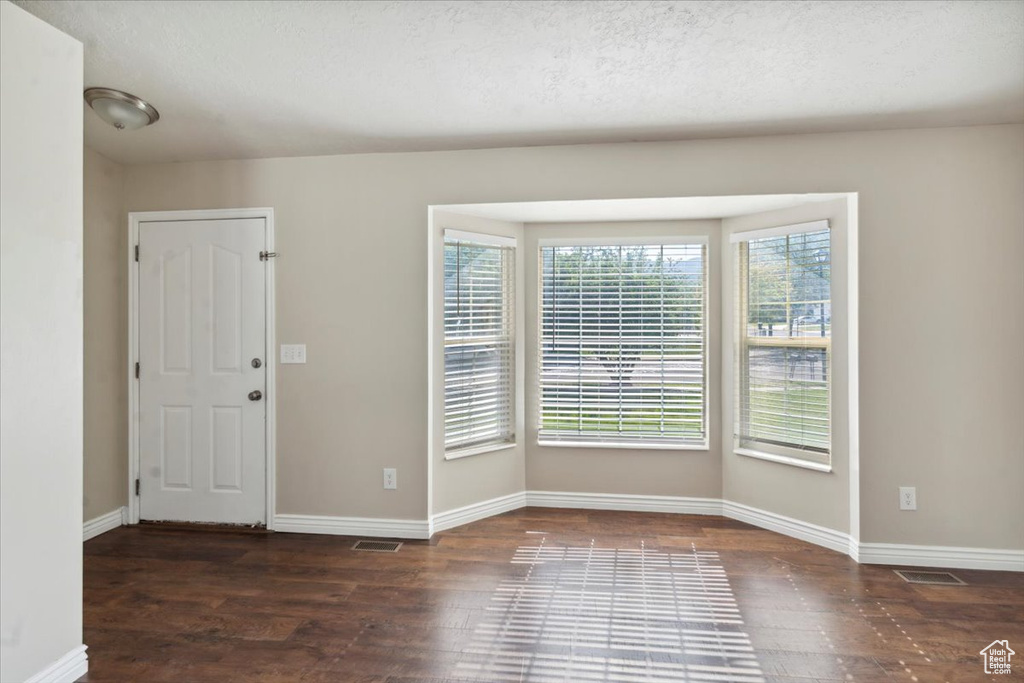 Foyer with wood finished floors and a textured ceiling