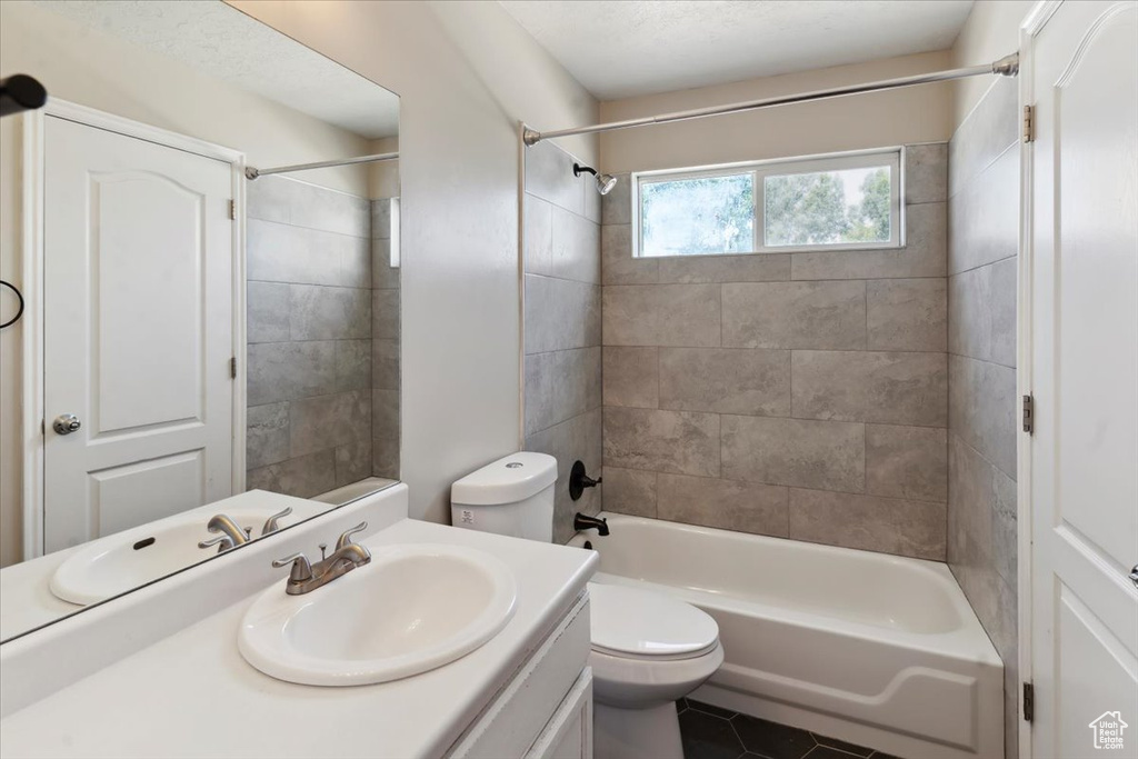 Bathroom with vanity, bathtub / shower combination, and tile patterned floors