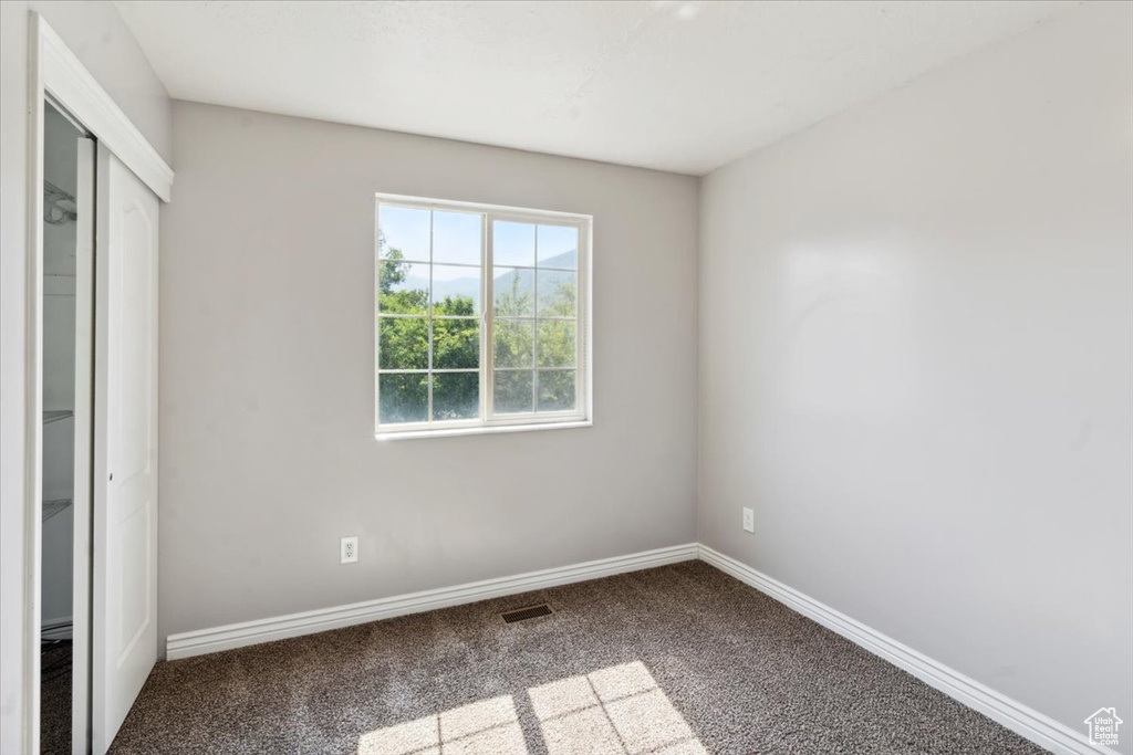 Unfurnished bedroom featuring carpet floors and a closet