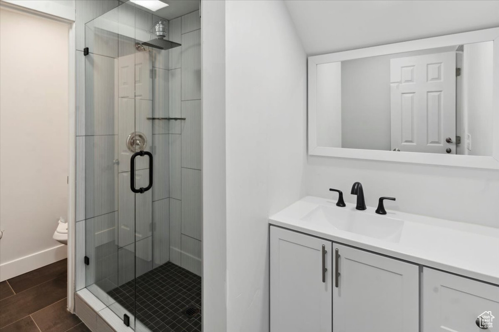 Bathroom with a shower stall and vanity