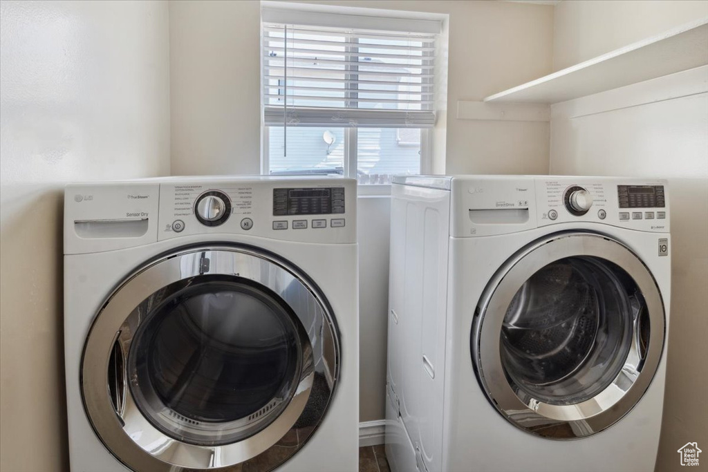 Laundry room with washer and clothes dryer