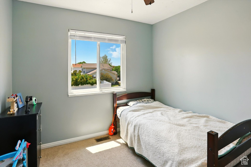 Bedroom with carpet flooring and a ceiling fan