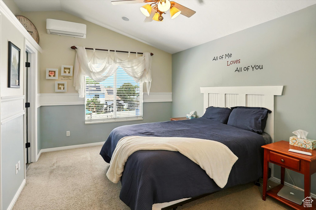 Carpeted bedroom featuring a wall mounted air conditioner, vaulted ceiling, and ceiling fan