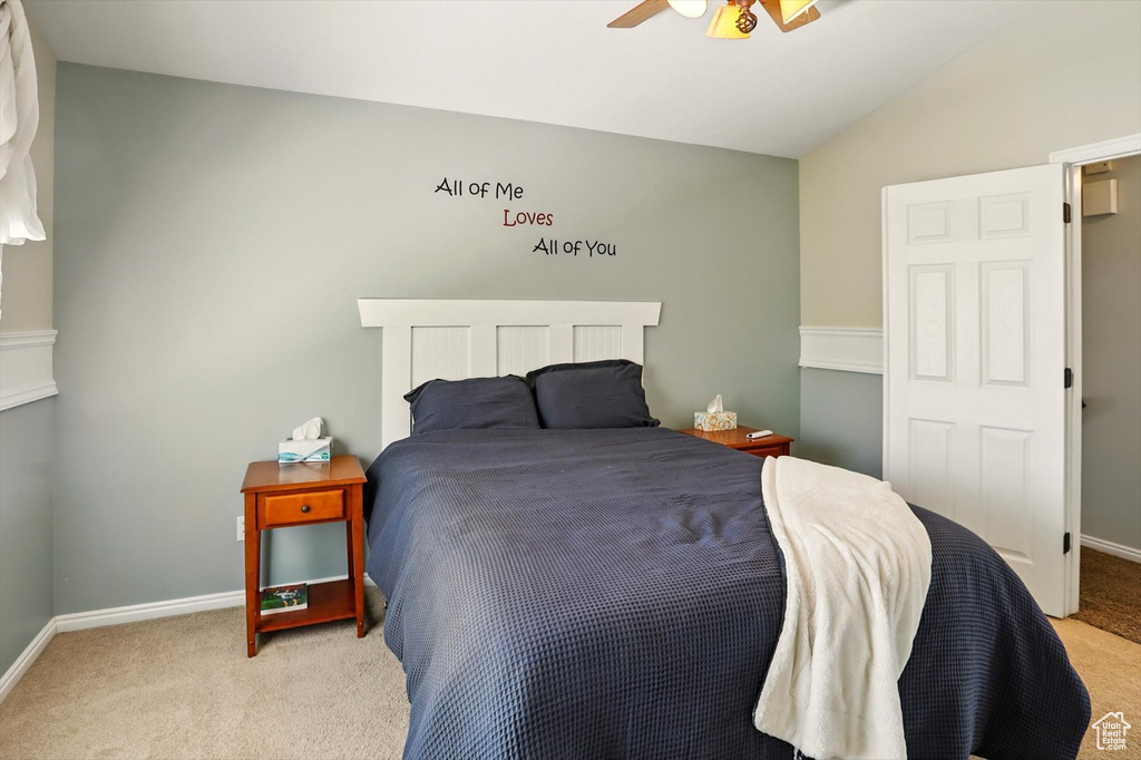 Bedroom with carpet floors, lofted ceiling, and a ceiling fan