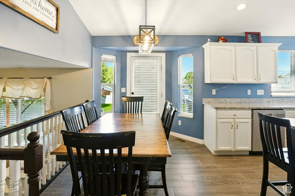 Dining space with dark wood-style flooring, recessed lighting, and lofted ceiling