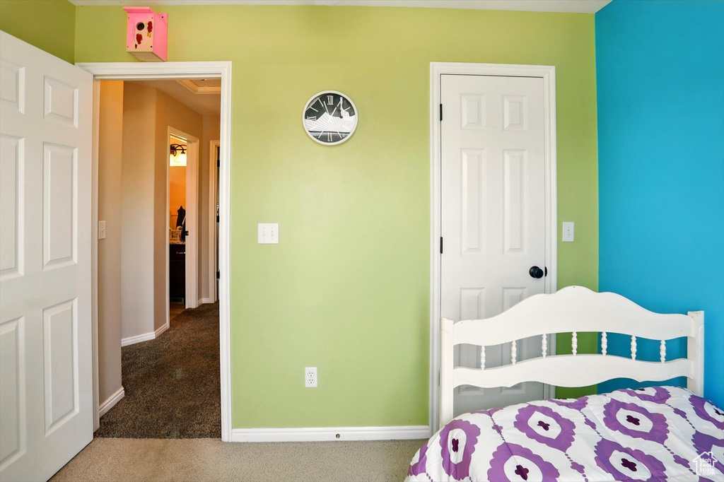 Bedroom featuring carpet flooring and baseboards