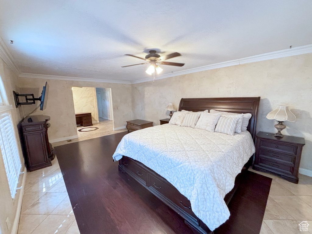 Bedroom featuring crown molding and a ceiling fan