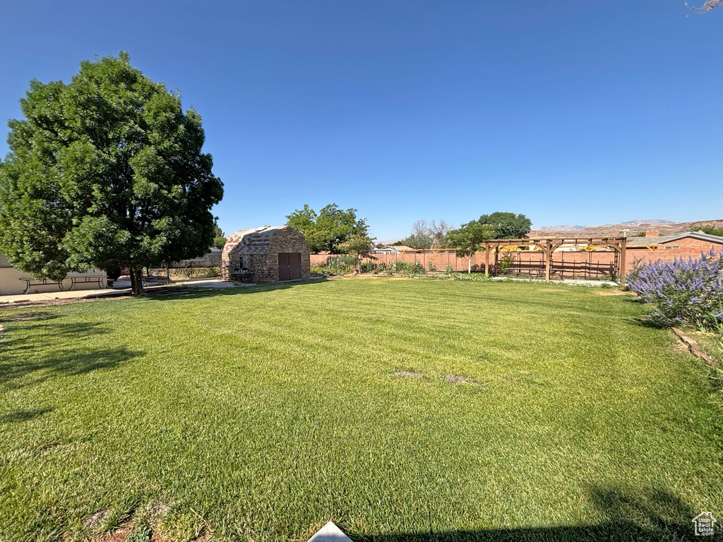 Fenced backyard with a storage shed