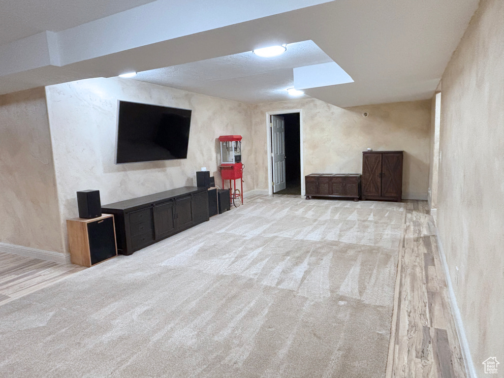 Finished below grade area with baseboards and carpet floors