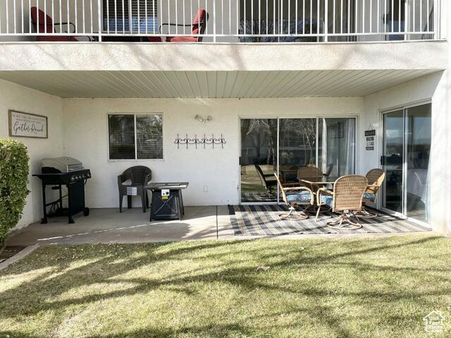 Patio / terrace featuring a grill, a patio area, and a lawn