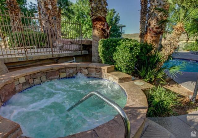 View of swimming pool with an in-ground hot tub and a pool
