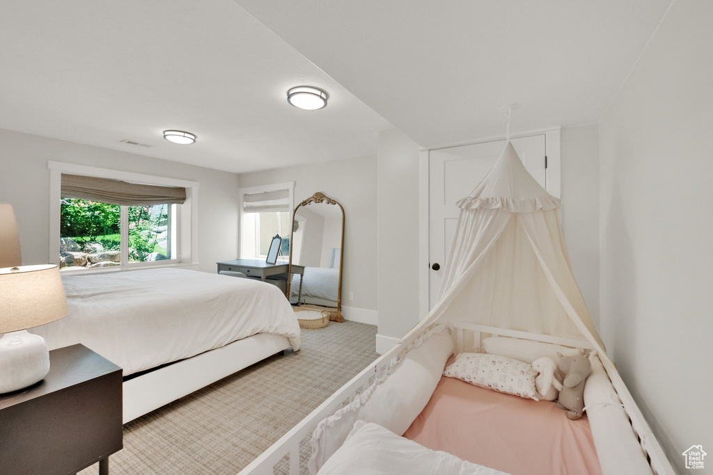 Bedroom featuring carpet and baseboards