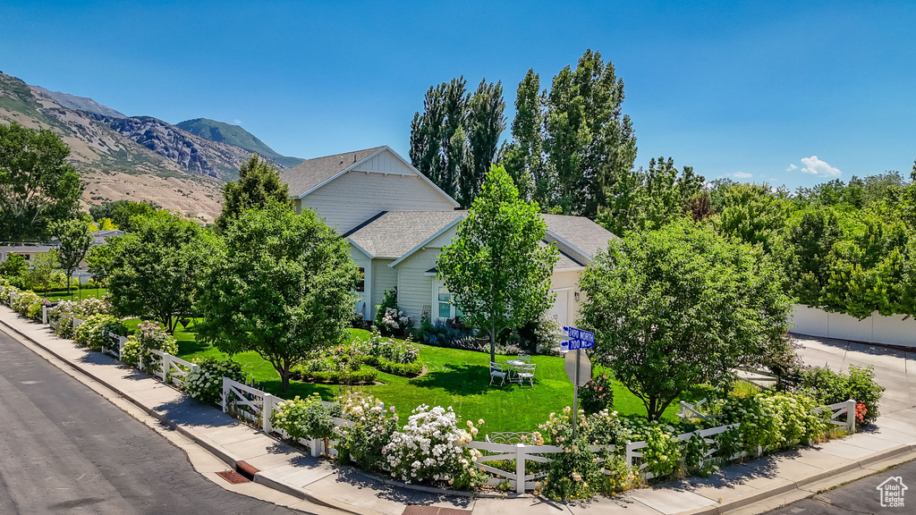 View of front of property with roof with shingles and a garage