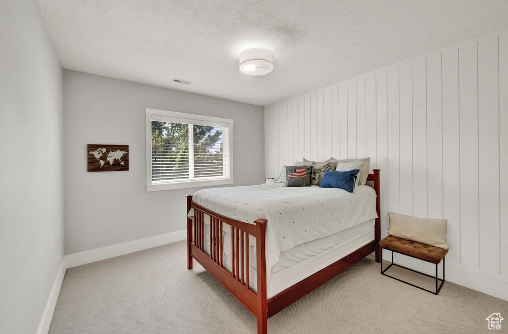Bedroom with light colored carpet