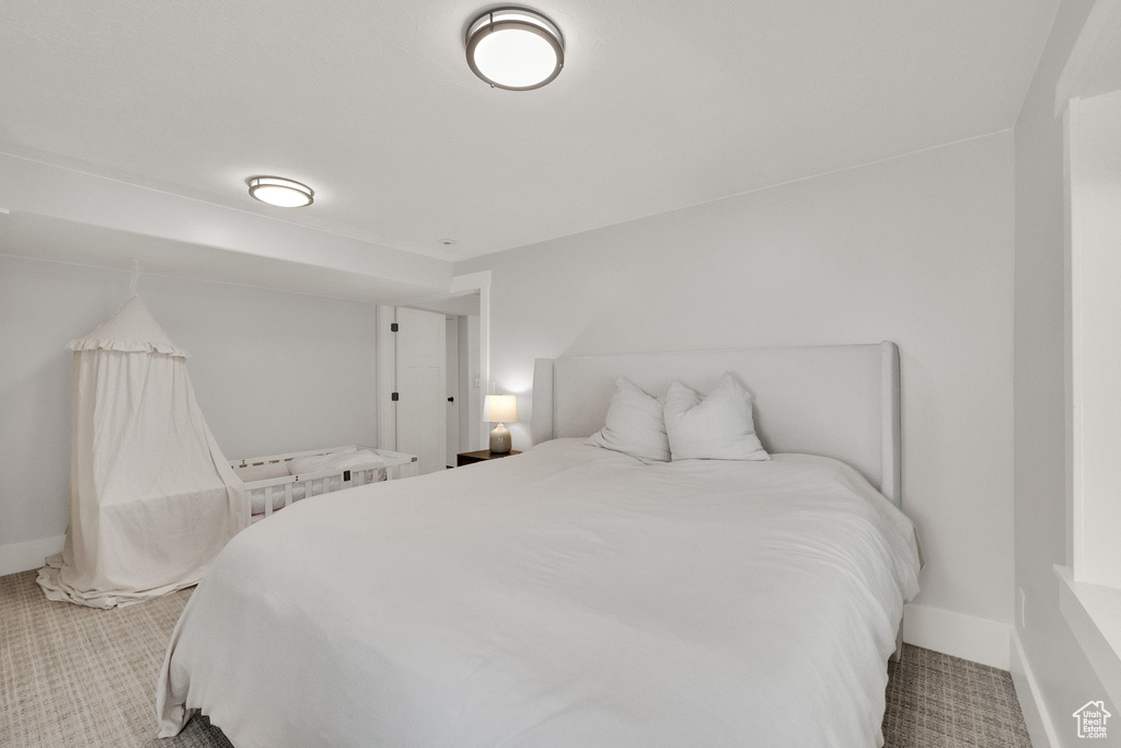 Bedroom with carpet floors and baseboards